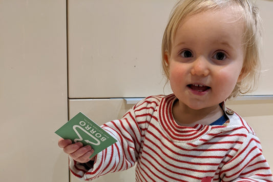 My littlest holding my new business cards