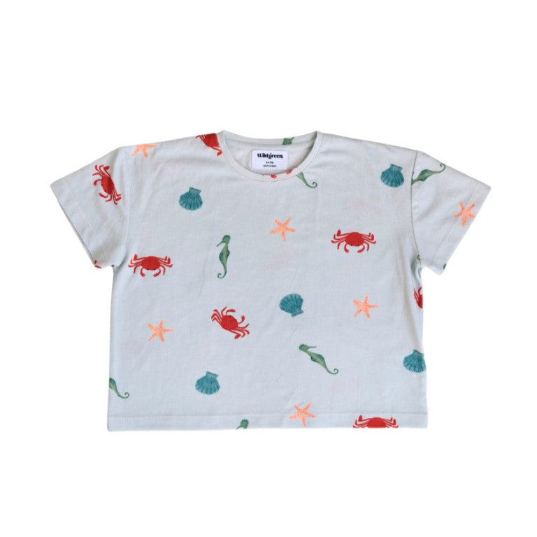 White t-shirt with colorful sea creature patterns on a white background