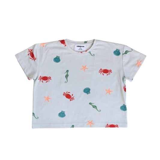 White t-shirt with colorful sea creature patterns on a white background