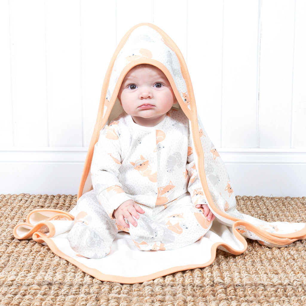 Baby wearing fox and squirrel sleepsuit
