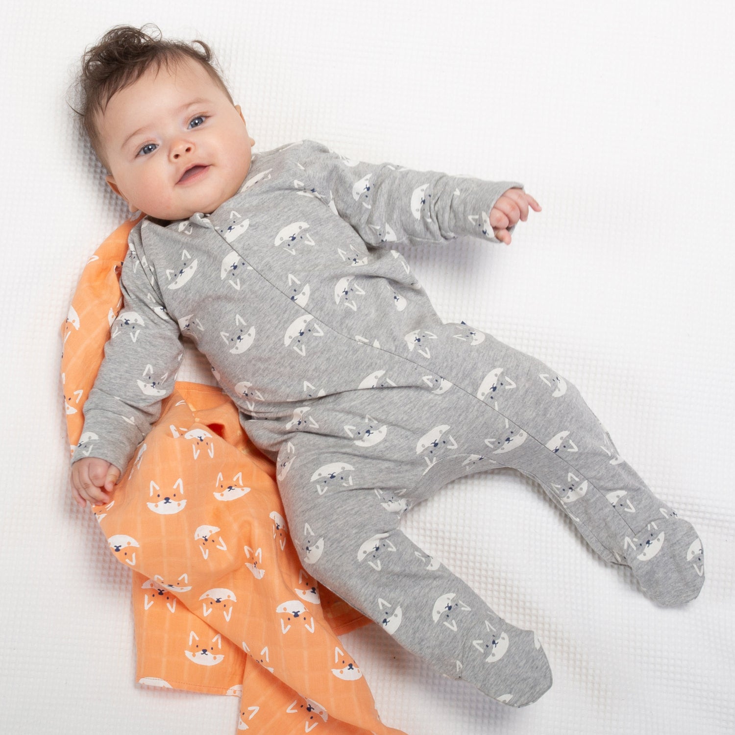 Baby wearing grey foxy sleepsuit