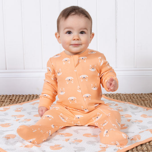 Baby wearing peach foxy sleepsuit