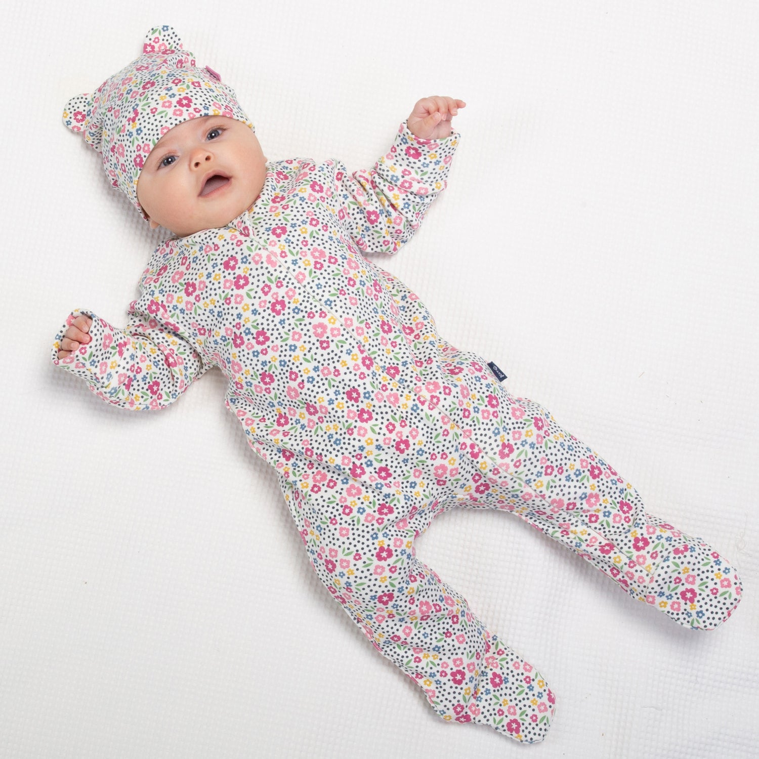 Baby wearing home ditsy baby sleepsuit