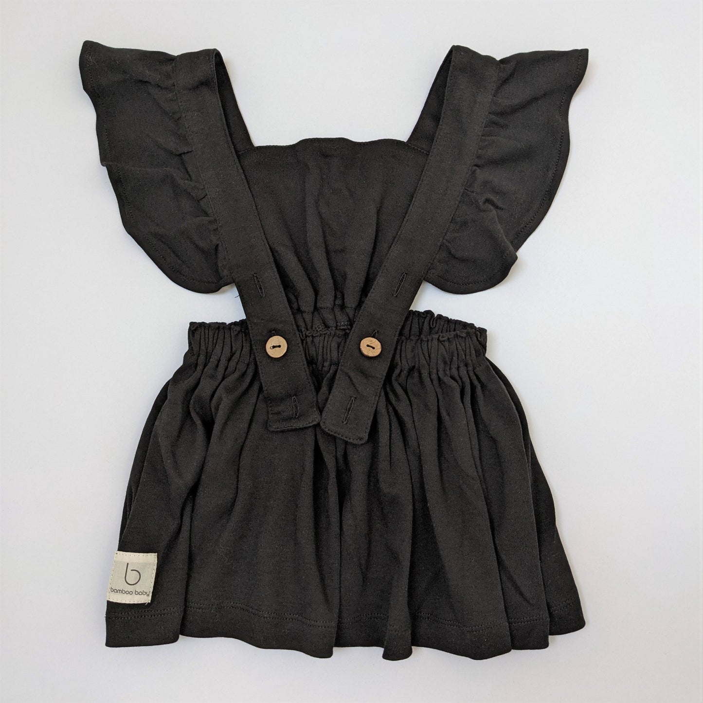 Back of black pinafore dress