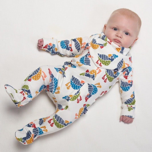 Baby wearing sleepsuit with puffling print