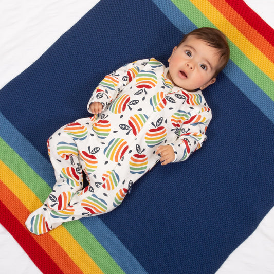 Baby wearing rainbow apple sleepsuit