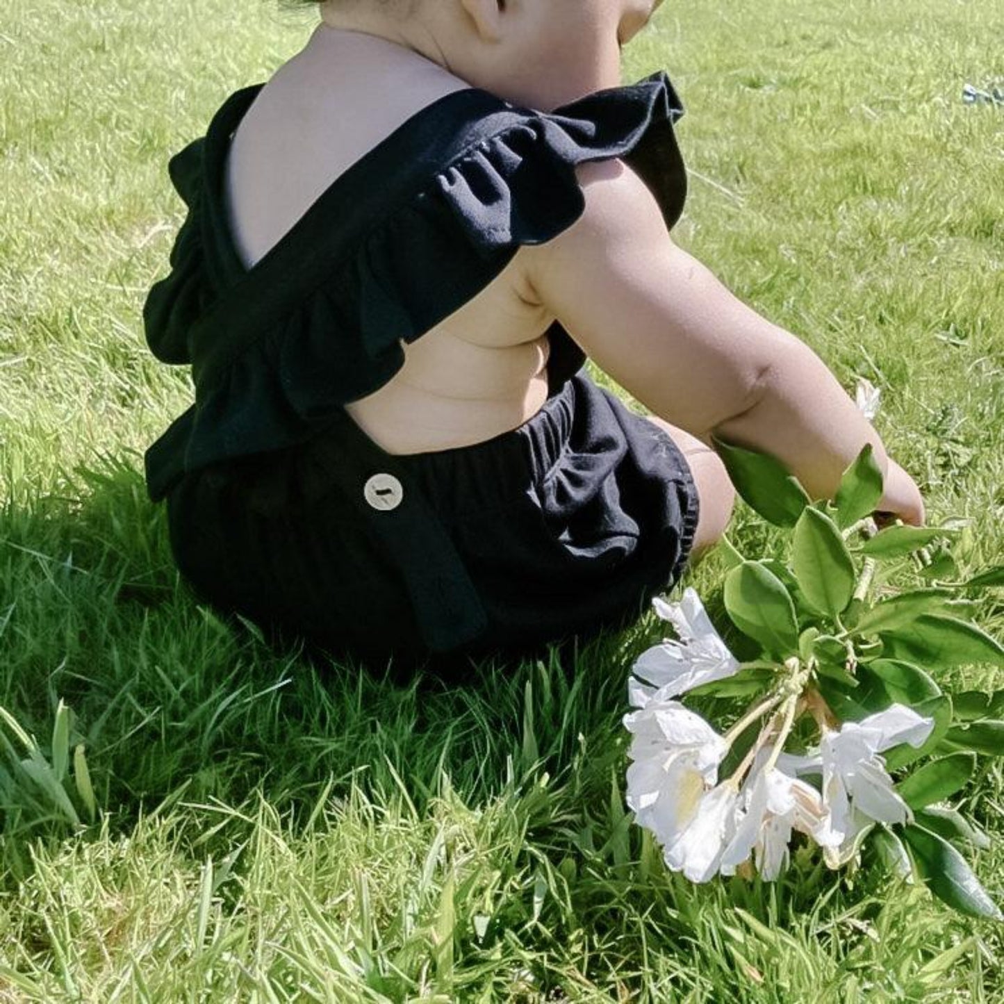 Baby wearing black harper romper