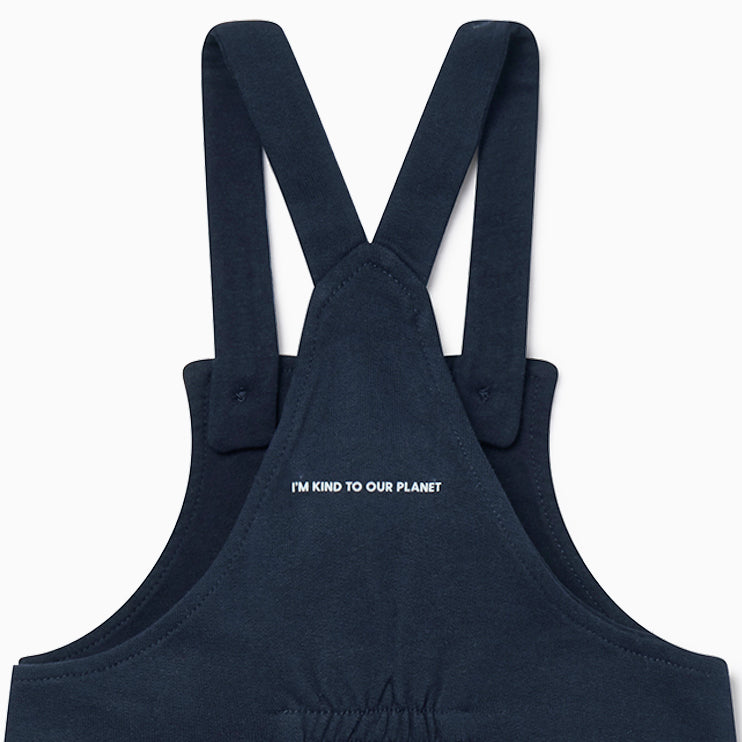 Back of navy dungarees with slogan